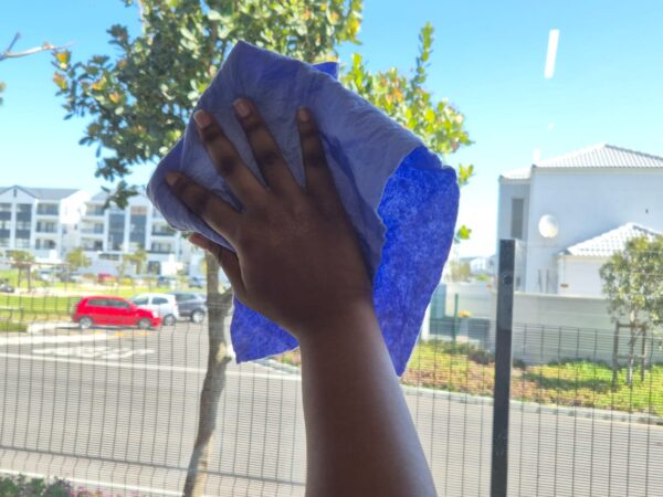 A picture of someone washing a window.