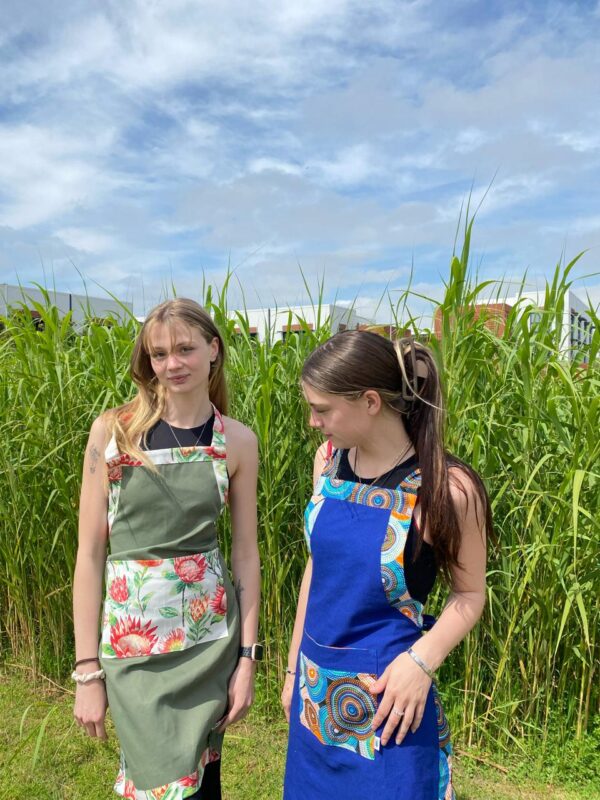 Two girls in aprons.