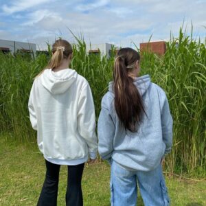 Two girls in hoodies.