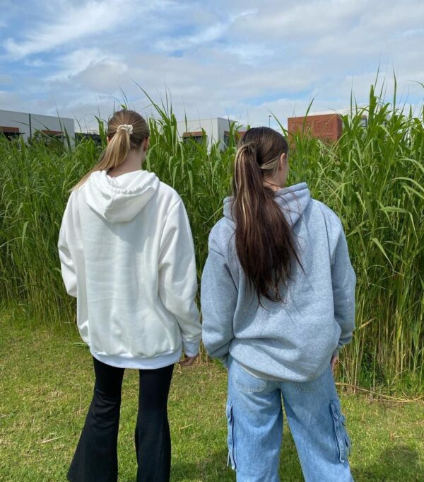 Two girls in hoodies.